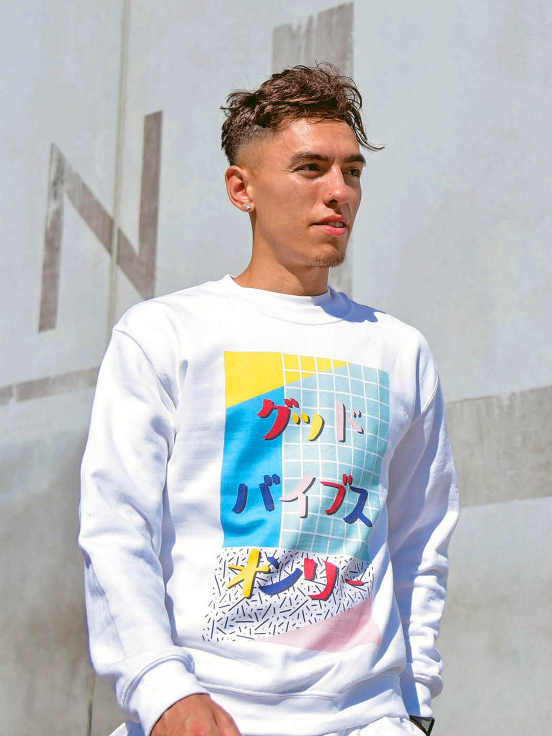 A white sweatshirt with a vaporwave Japanese design on it.