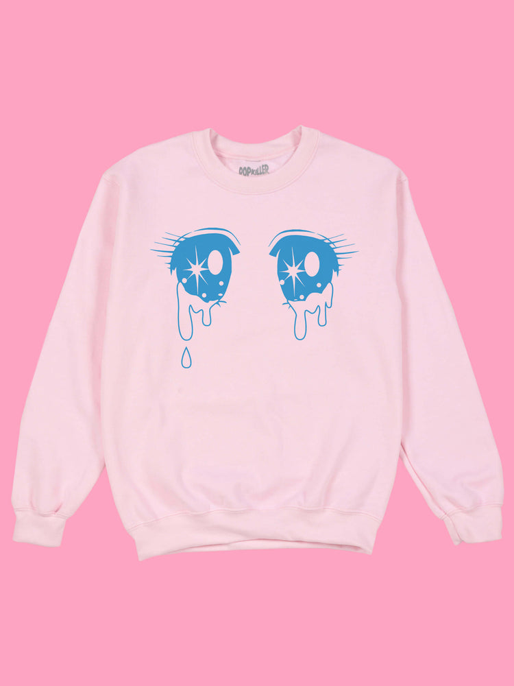 A pastel pink sweatshirt with mahou shoujo anime eyes on it.