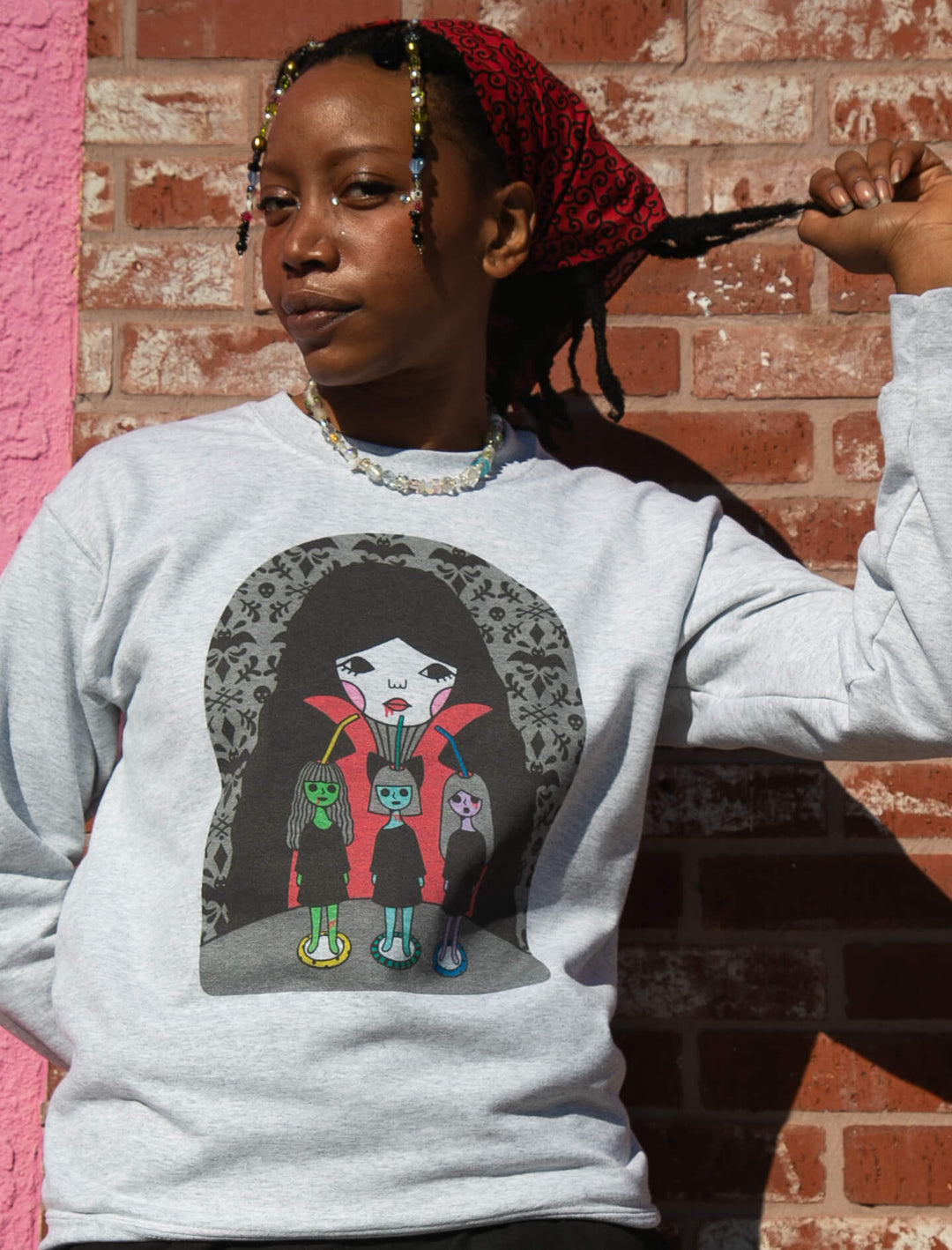 Model wearing artist designed vampire girl graphic sweatshirt.