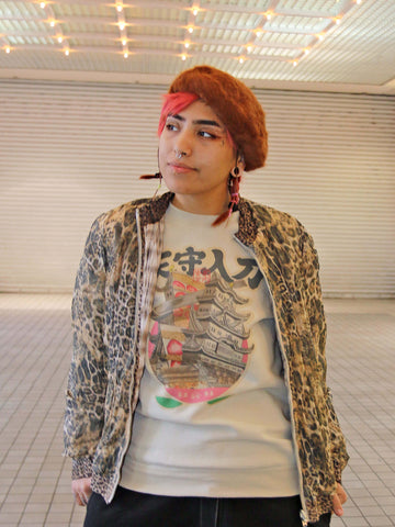 Model wearing a retro Japanese cake castle sweater.