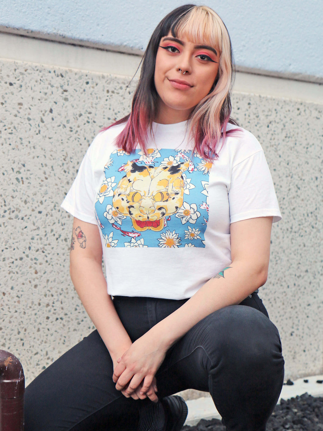A model wearing a white Japanese cat and koi fish t-shirt.