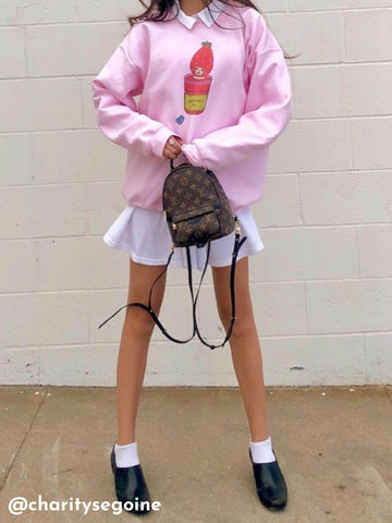 Model wearing an oversized pink kawaii sweatshirt.