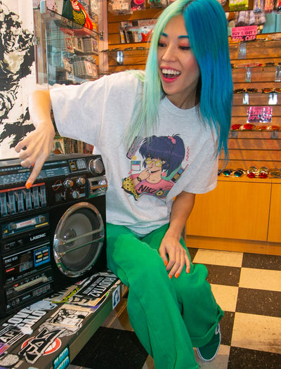 Model wearing vaporwave 80s retro anime aesthetic graphic t-shirt.