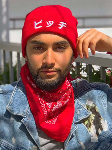 Red beanie that reads 'bitch' in Japanese.
