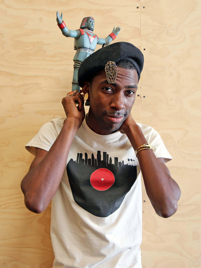 Beige graphic tee with a vinyl record city design by Los Angeles brand Popkiller.