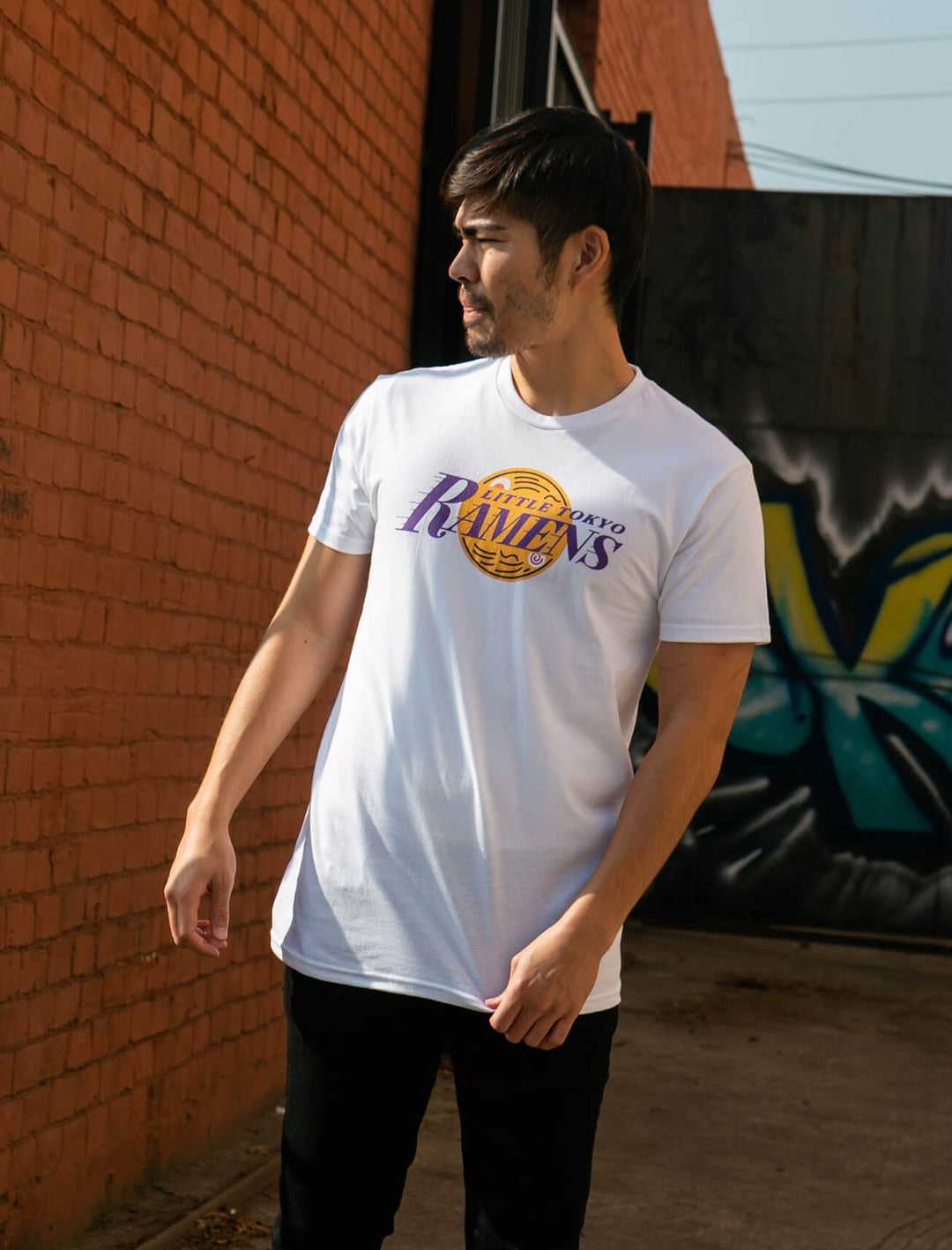 Model wearing LA Lakers and ramen inspired graphic apparel.