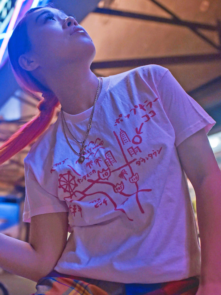 A model wearing a pastel pink Japanese map of LA t-shirt.
