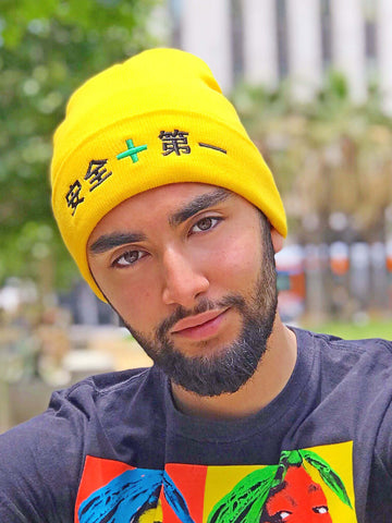 Yellow beanie that says 'safety first' in Japanese.