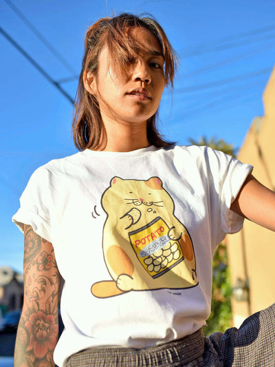 Model wearing a graphic t-shirt of a cute cat eating chips.