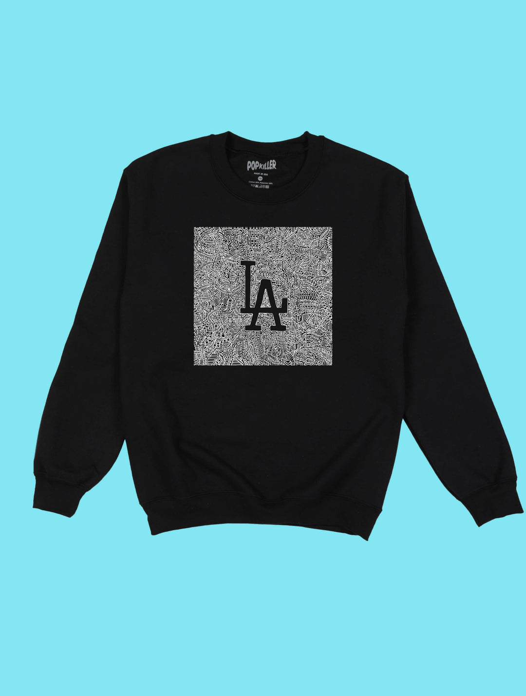 White illustration of Los Angeles on a black graphic sweater.
