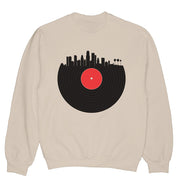 Sand colored sweatshirt with a record and the city of LA on it.