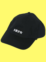 A black baseball hat with the words 'Bad Girl' printed on the front in Japanese.