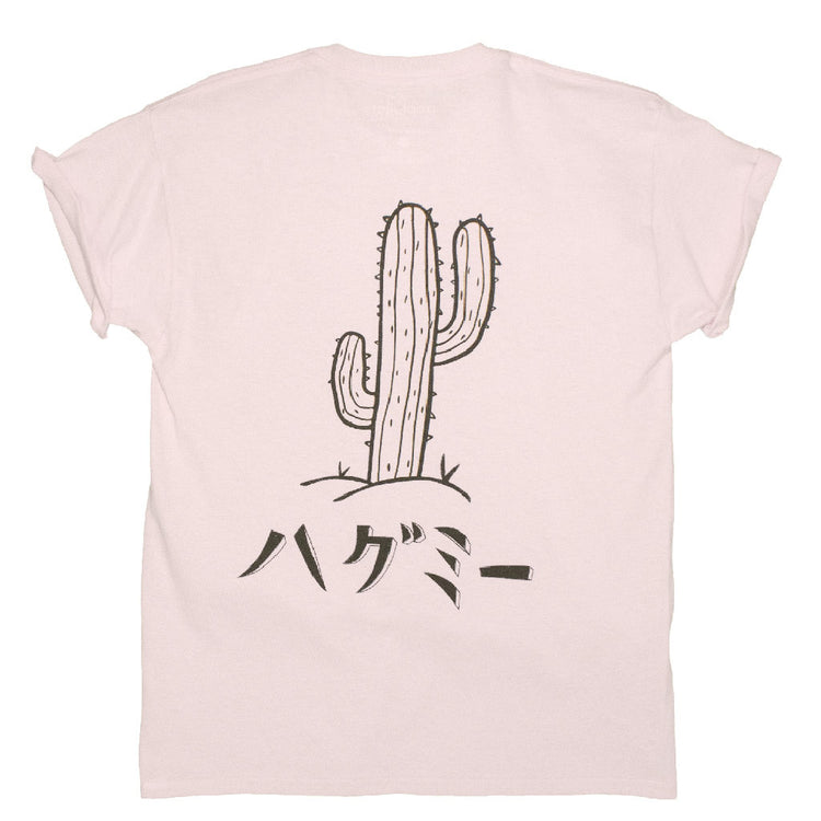 Pink back print graphic tee with a cactus illustration that reads 'hug me' in Japanese underneath.