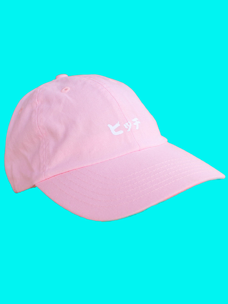 Pink polo cap with Japanese street slang printed on it.