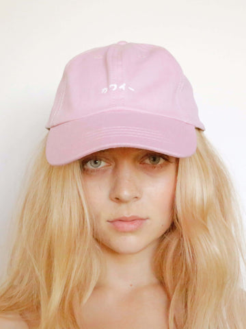 A model wearing a pastel pink kawaii baseball cap.