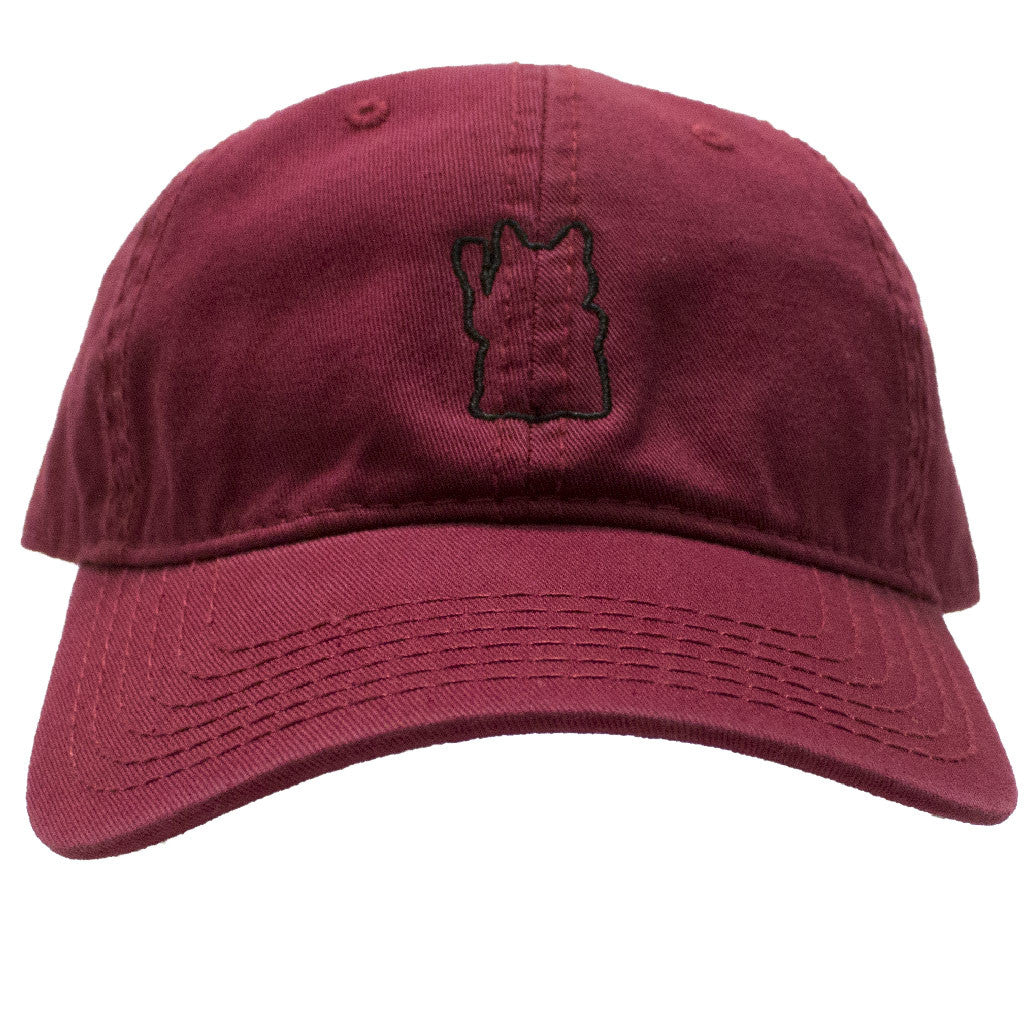 A maroon baseball cap with a lucky cat outline on it.