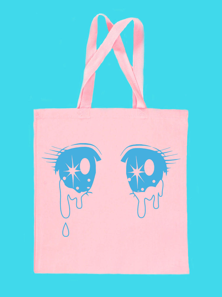 A pink kawaii tote bag with crying shoujo anime eyes printed on it.