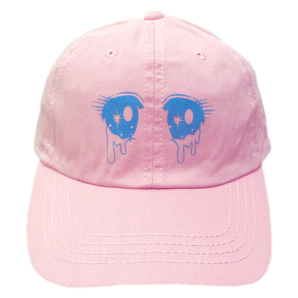 A pastel pink baseball hat with shoujo eyes on it.