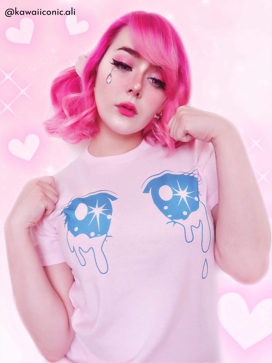 A kawaii pink graphic tee with sparkling anime eyes.