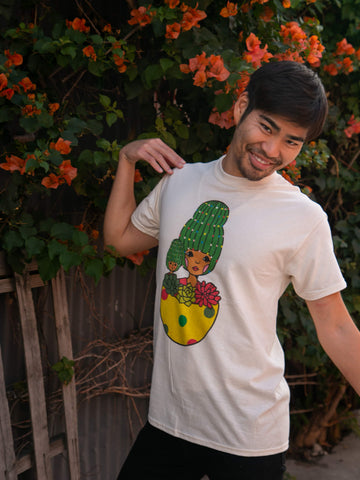 Model wearing christmas graphic tee with cactus pot designed by sunae artist Naoshi.