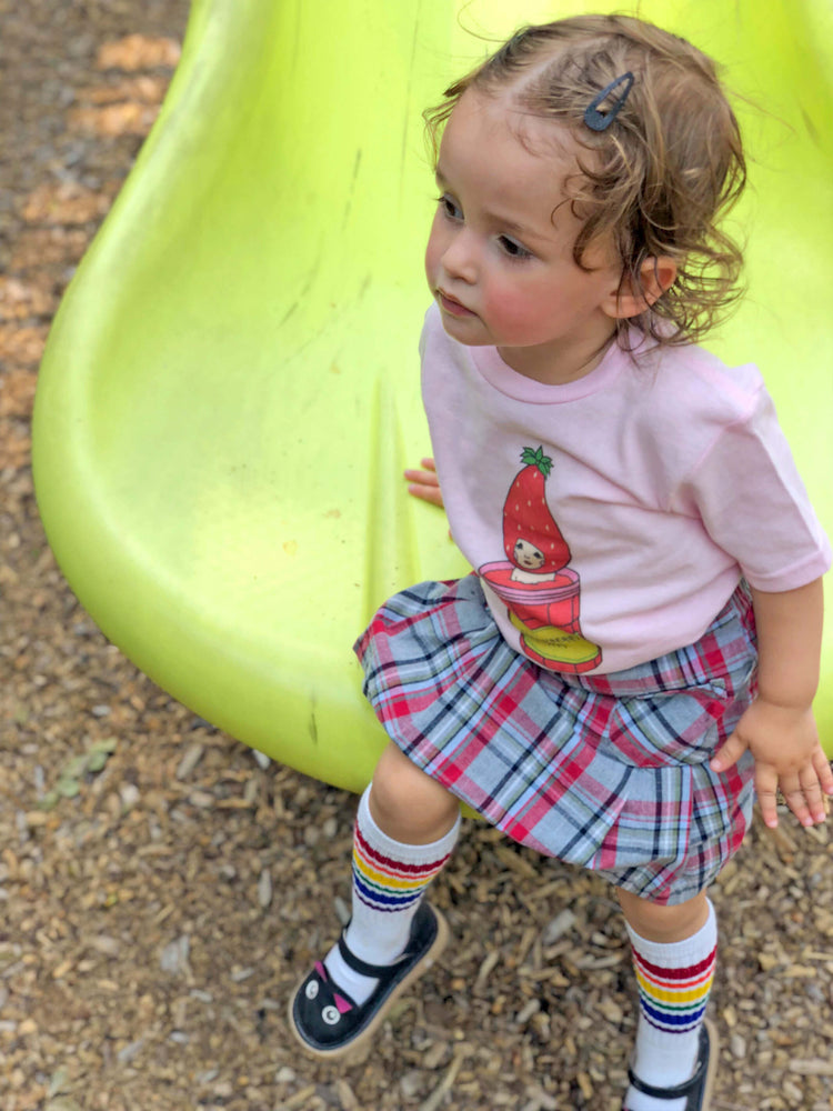 Model wearing a kawaii strawberry kid's tee.