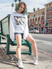 A model wearing a white sweatshirt with an ukiyo-e skeleton print on it.