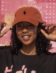 Model wearing cap with a shogun logo design parodying a famous fashion brand.