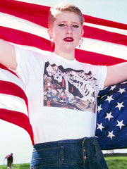 A model wearing a white graphic tee with a Japanese skeleton print on it.