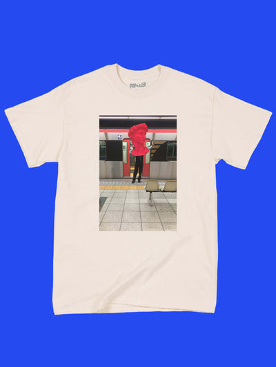 A beige tee with a vaporwave Japanese subway photo on it.
