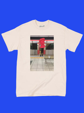A beige tee with a vaporwave Japanese subway photo on it.