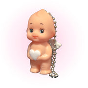 Baby cherub holding a white heart kewpie doll keychain.
